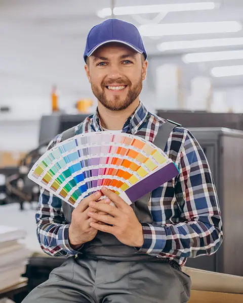 a person holding a fan of color swatches